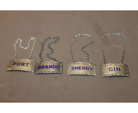 A SET OF FOUR HALLMARK SILVER DECANTER LABELS BLUE LETTERING