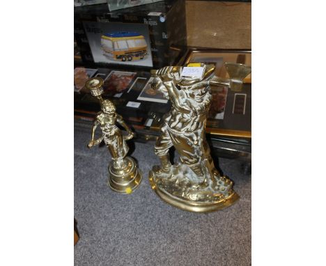 A BRASS FIGURATIVE CANDLESTICK TOGETHER WITH A BRASS FIRESIDE ORNAMENT (2)