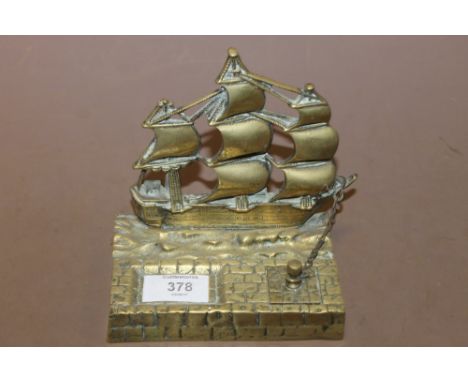 A BRASS DESK STAND WITH SHIP FINIAL