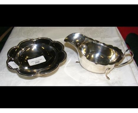 A silver sauce boat, together with a silver Mappin &amp; Webb lotus bowl 