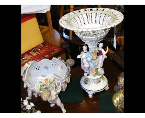 A decorative 46cm high ceramic table centre, together with one other 