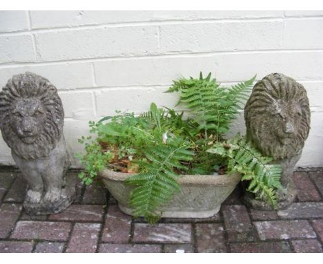 A pair of decorative garden lion ornaments, together with a small trough 
