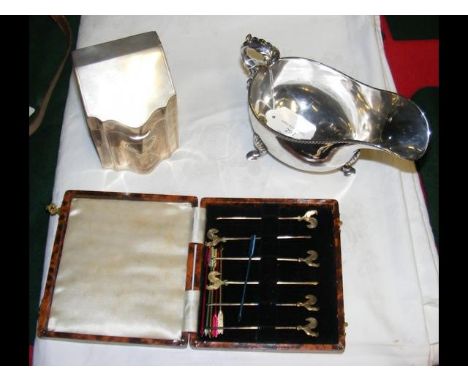 A silver tea caddy with Sheffield hallmark, together with a sauce boat and cased cocktail sticks 