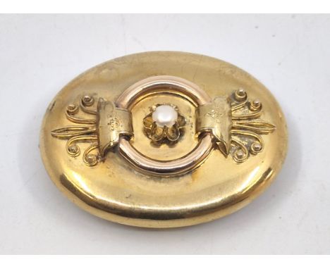 A Continental 18ct. gold oval mourning brooch,&nbsp;having applied bi-colour gold decoration to front set single cultured pea