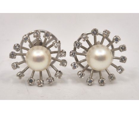 A pair of white metal, diamond and cultured pearl earrings,&nbsp;with dished circular mount prong set eight-cut diamond to ea