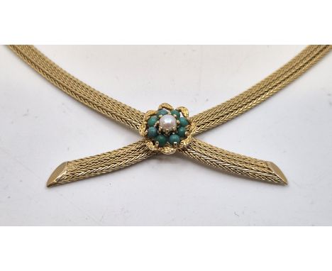 A 9ct. gold choker necklace, fashioned from two flat foxtail type link chains hinged below textured flower form mount set cen