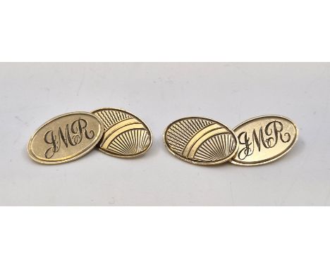 A pair of 9ct. gold oval cufflinks, Birmingham 1965, chain fitting, one half engine turned, the other with engraved monogram.