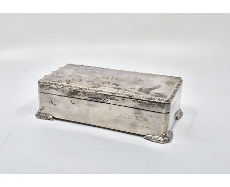 A silver rectangular cigarette box, by Adie Brothers Ltd, Birmingham 1960, with Celtic design rim to hinged lid and bracket s
