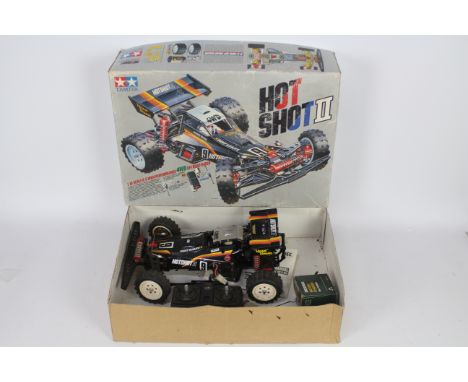 Tamiya - An assembled and boxed Tamiya 1:10 scale RC 'Hot Shot II' High Performance Off Road Racer. The model shows signs of 