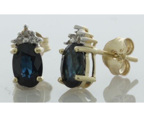 These 9ct yellow gold stud earrings have an oval 6mm x 4mm sapphire with a cluster of three round brilliant cut diamonds sitt