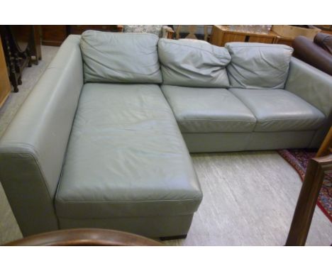 A modern cushioned grey hide upholstered, two part L-shaped settee, having a low, level back and arms, raised on block feet  