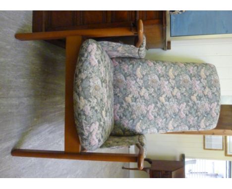 A modern Cintique beech framed recliner armchair, upholstered in a floral tapestry fabric, raised on block legs         CA