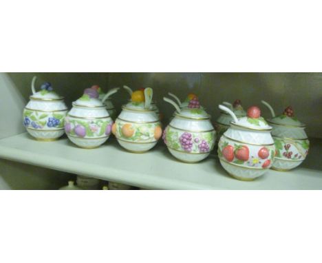 A set of ten Le Cordon Blue china preserve pots  4''h displayed in a hanging wall shelf      OS1