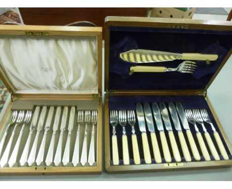 A set of six stainless steel dessert knives and forks, in a fitted fabric lined stained oak case; and a set of six stainless 