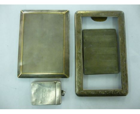 Three silver items, viz. a rectangular photograph frame with scratch engraved decoration, on an oak back  5.5'' x 3.5''; two 