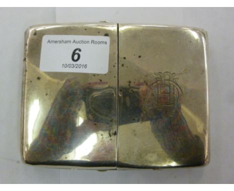 An Edwardian silver curved, cushion shaped cigarette case, the pair of hinged flaps, on opposing button clasps, enclosing thr