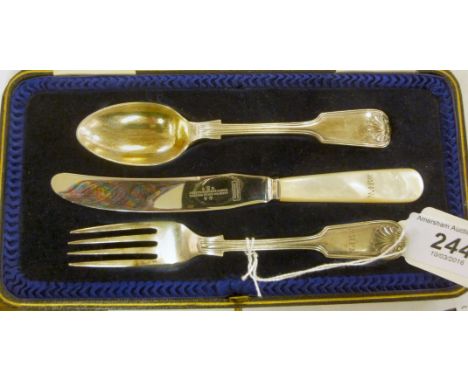 A three piece Christening set  comprising a fiddle, shell and thread pattern fork and spoon and matched knife, the steel blad