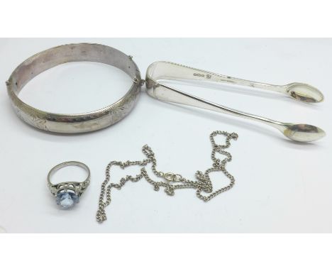 A white metal bangle, a pair of silver sugar bows, a silver chain and a silver ring, 56.4g 
