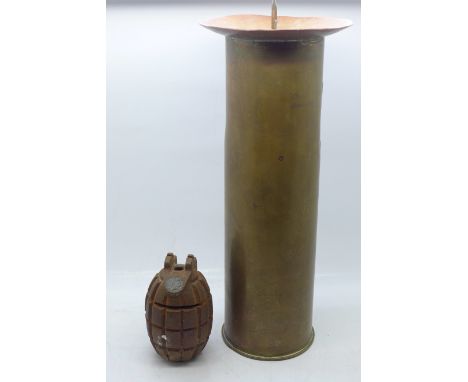 A military 75mm shell case made into a large candlestick, a grenade made into a money box, trench art lighter, buttons, bulle