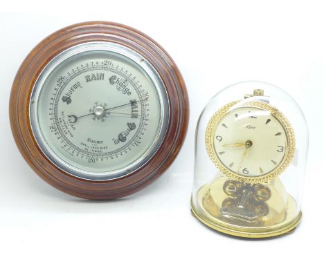 A torsion clock by Kundo and a British made barometer 