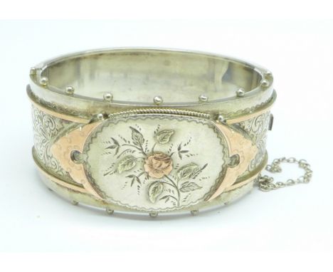 A Victorian bangle with applied gold decoration 