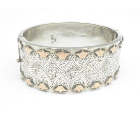 A Victorian silver bangle with applied gold decoration, Birmingham 1885 