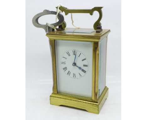 A brass and glass four glass sided ACG English carriage clock, with key 