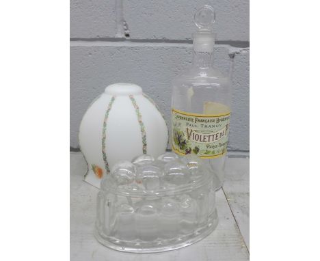 A glass lamp shade, a glass jelly mould and a chemist bottle **PLEASE NOTE THIS LOT IS NOT ELIGIBLE FOR POSTING AND PACKING**
