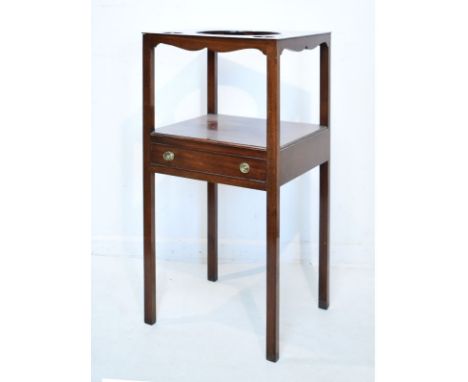 George III mahogany two tier washstand, the top with three apertures, platform below fitted one drawer and standing on bracke
