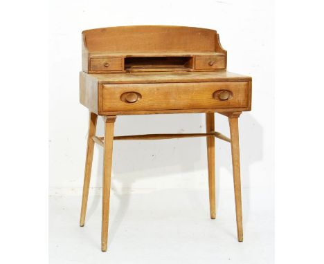 Ercol light elm and beech writing table, the raised back fitted an one shelf and two short drawers, one long drawer to the fr