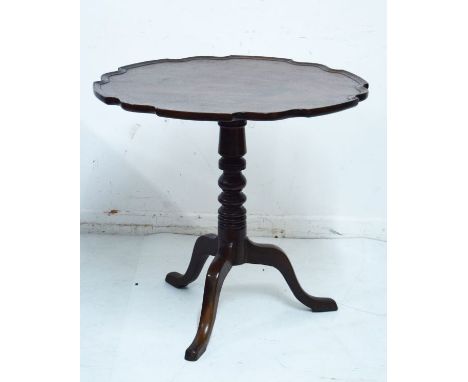 Mahogany circular snap top supper table having a pie crust edge and standing on a turned pillar and tripod base   Condition: 