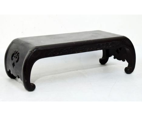 Early 20th Century Chinese lacquered low table, the scroll ends having pierced decoration, the underside with trade stamp for