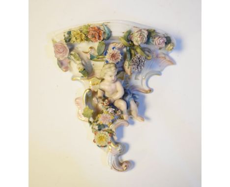 Continental porcelain figural wall bracket decorated with a cherub amongst foliage   Condition: 