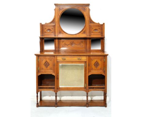 Late Victorian carved walnut chiffonier, the raised back fitted three bevelled mirrored panels, open shelf supported by slend