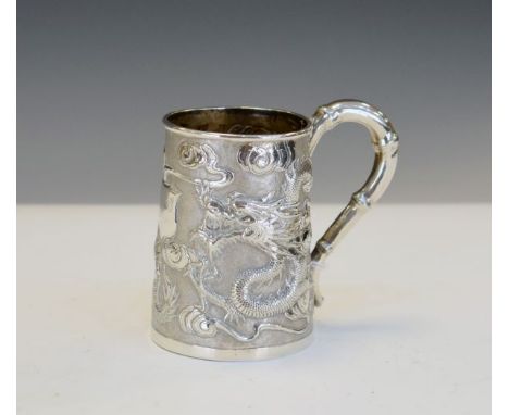 Small early 20th Century Chinese export silver mug typically decorated with dragons on a pitted ground, bamboo scroll handle,