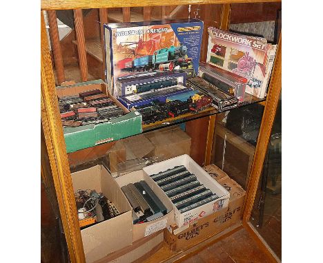 Whole cabinet (2 shelves) containing Lima, Mainline and Hornby Triang 00 gauge rolling stock, locomotives x 12, and carriages