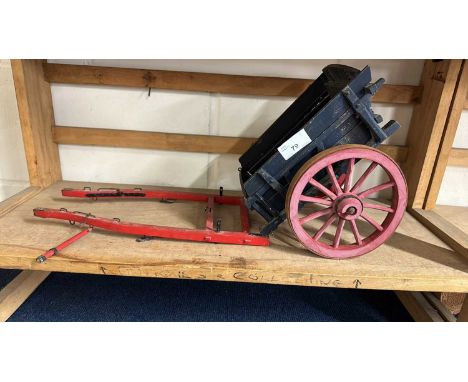A scratch built model of a single axle cart painted in red and blue, approx 50cm long