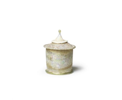  A Roman green glass lidded pyxis Circa 1st Century A.D.The cylindrical body with hollow tubular flanges at the top and botto