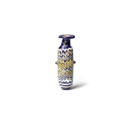  An Eastern Mediterranean core-formed glass alabastron Circa 4th-2nd Century B.C.Of dark blue glass, the cylindrical body wit