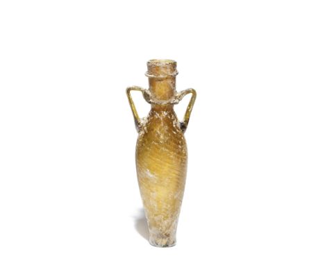  A Roman amber glass tall amphoriskos Circa 5th Century A.D.The funnel neck with two bands of trail decoration, the angled tw