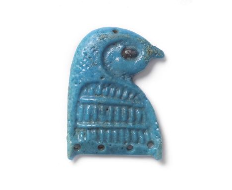  An Egyptian turquoise faience falcon head terminal Third Intermediate Period, circa 1069-735 B.C.Flat backed, the crown of t