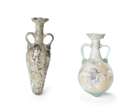  A Roman pale blue-green glass pilgrim flask and a Roman green glass amphoriskos Circa 2nd-4th Century A.D.The flask with cir