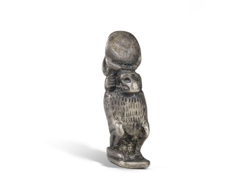 An Egyptian electrum amulet of Thoth New Kingdom-Third Intermediate Period, circa 1550-715 B.C.The god squatting on his haun