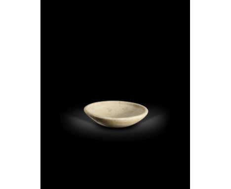  A Cycladic marble bowl Early Cycladic II, circa 2700-2200 B.C.With a slightly flattened base, the flaring sides with an inwa