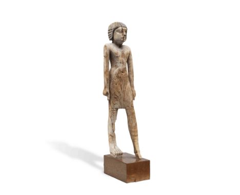  An Egyptian wood figure of a man Old Kingdom, 6th Dynasty, circa 2300-2181 B.C.Striding forward with the left leg advanced, 