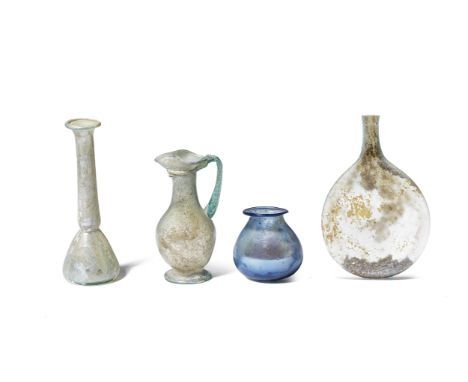  Four Roman glass vessels  Late Roman-Early Byzantine, circa 1st-6th Century A.D.Comprising a pilgrim flask, the cylindrical 