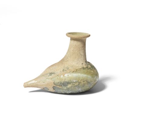  A Roman pale green glass feeder flask Circa 2nd-3rd Century A.D.The body modelled in the shape of a bird, the extended tubul