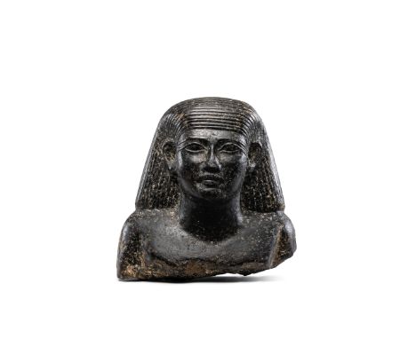  An Egyptian granite bust of an official New Kingdom-Third Intermediate Period, circa 1550-655 B.C.Wearing a shoulder-length 