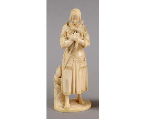 DIEPPE IVORY FIGURE OF JOAN OF ARC, 19th century, standing holding s sword, her helmet and gloves on a trunk to her side, hei