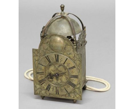 BRASS LANTERN CLOCK, the dial with 6 1/2" chapter ring and single steel hand in an engraved scrolling frame and beneath a bos